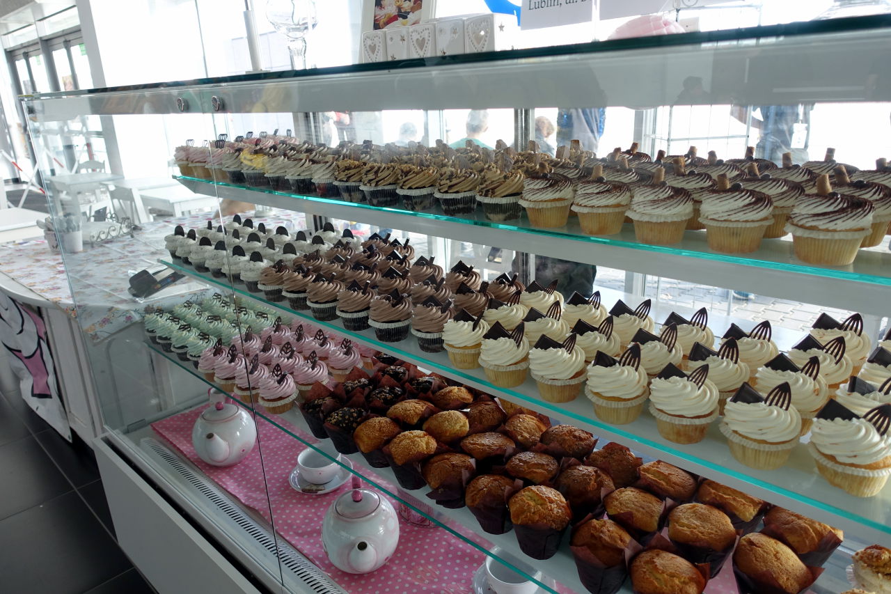 Picture shows a stall with rows of cupcakes