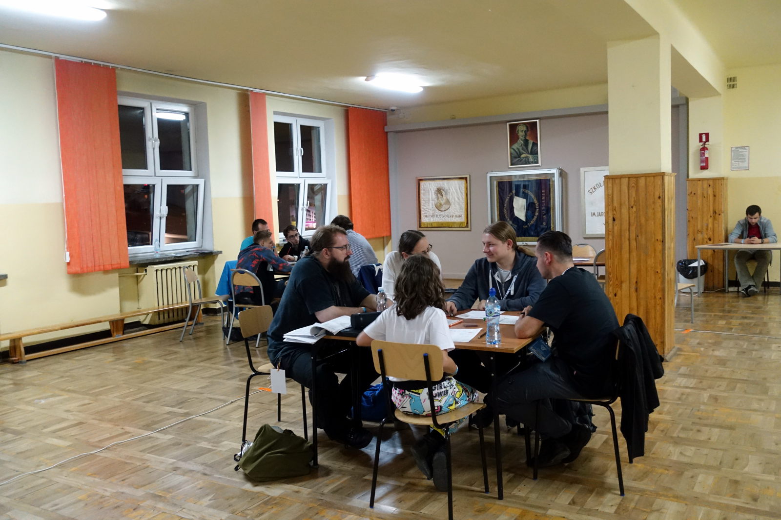 A group of people sitting around a table and playing RPG.