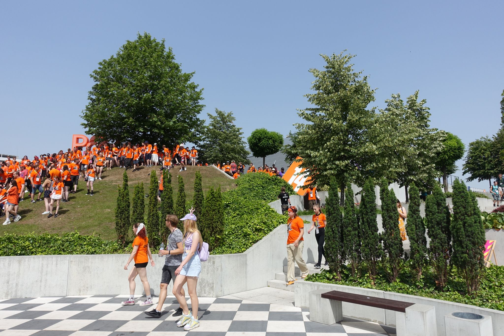 Multiple people in orange standing on the hillside.