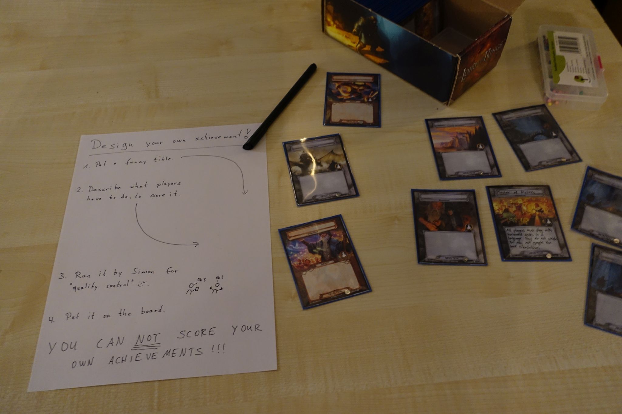 A piece of paper with some intruction and gaming cards on a table.